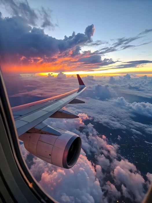 Airplane window at sunset